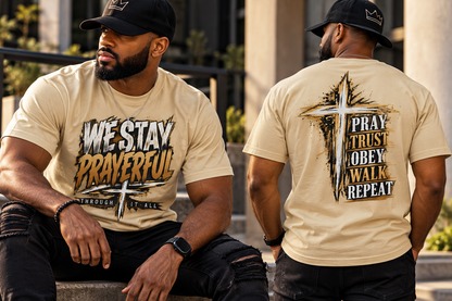 Model wearing We Stay Prayerful heavyweight Christian T-shirt with Pray Trust Obey Walk Repeat back design